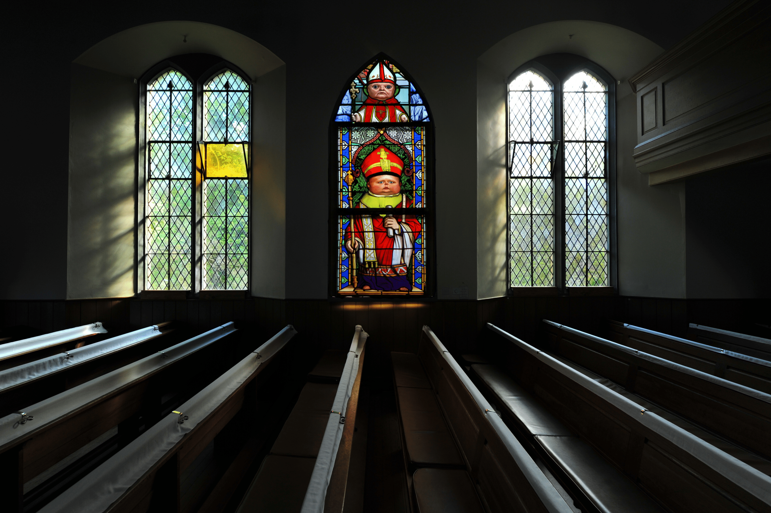 Stainglass window design in a church, satirical priests.